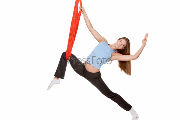Stock Photo: Young woman doing anti-gravity aerial yoga
