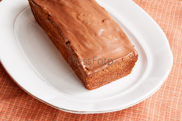 Homemade cake with glaze of chocolate in the white dish