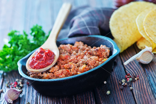 A bowl of fried ground meat with tomatoes ready for tacos, stock photo