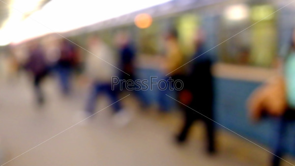 People walking on train station, blurred background