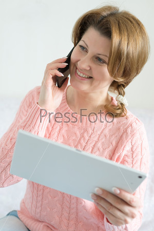 Positive woman with tablet computer in the hands