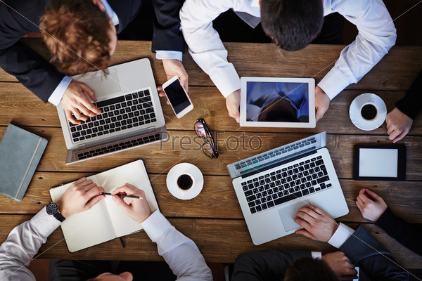 Group of business people using modern gadgets at workplace