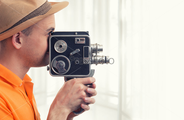 cameraman make film on a retro camera