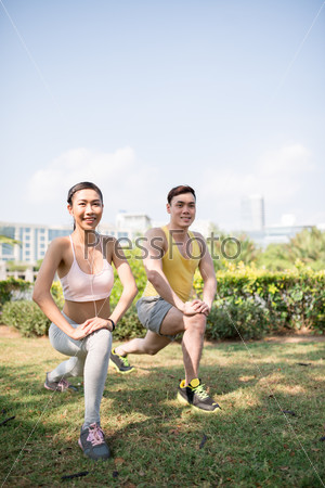 Young Vietnamese couple exercising in the park