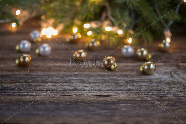 christmas background  - wooden table with defocused lights and decorationd