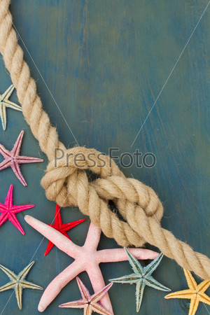 marine rope with starfish on blue background with copys space