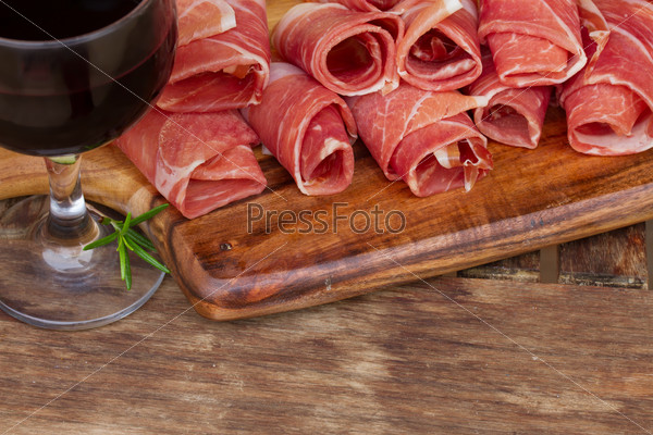 spanish tapas  - slices of cured pork ham jamon with  red wine
