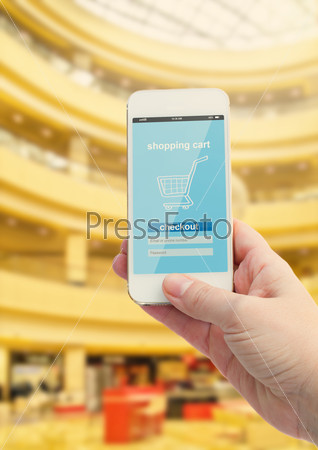 mobile shopping concept -  virtual shop on phone screen with normal shop in background