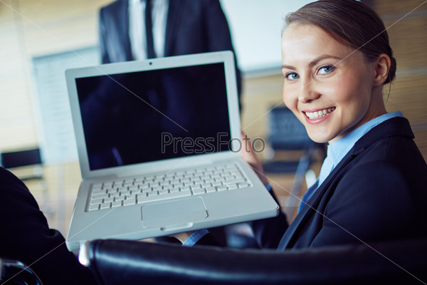 Happy businesswoman looking at camera during presentation, stock photo