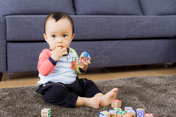Asian baby boy with finger in mouth