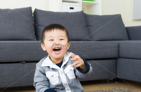 Asian little boy laugh in living room