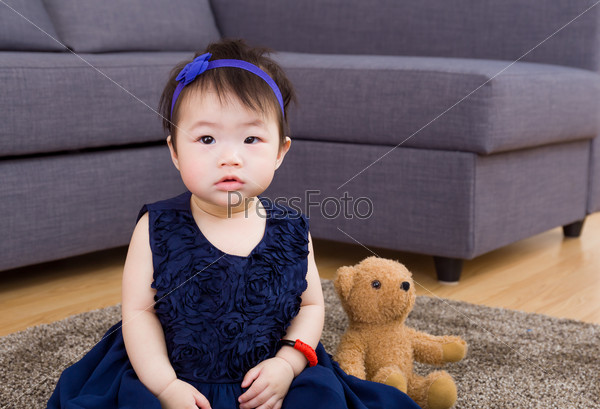 Baby girl and doll bear