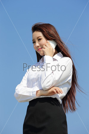 Successful business woman speak phone with blue sky, asian beauty