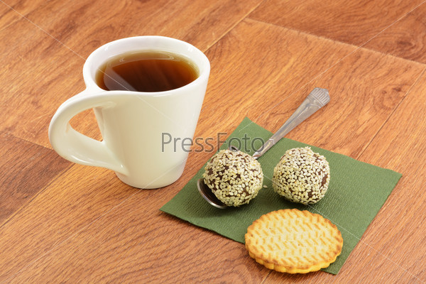Cake and tea on green napkin wooden background