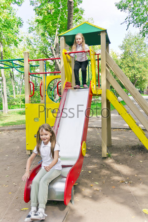 Photo of two active girls on nursery platform