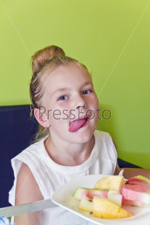 Portrait of eating girl with put out tongue