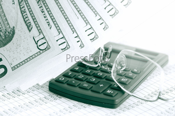 Financial background. Closeup of ten dollar notes near calculator and spectacles