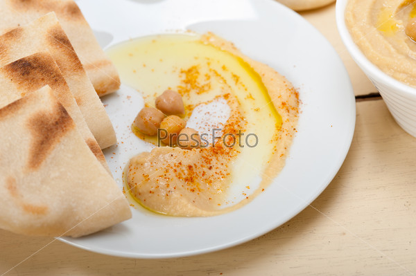 Traditional chickpeas Hummus with pita bread and paprika on top , stock photo