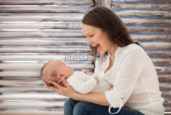 Portrait of mother and child laughing and playing