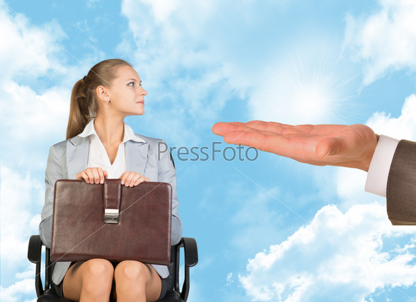 Young woman sitting in chair and looking to right at mans offering hand. Business man offering  job