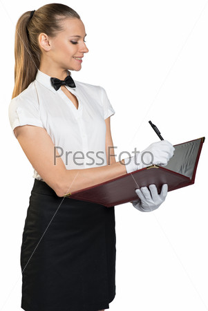 Young waitress standing profile, with teeth smile in white gloves, holding an open folder and writing. looking at folder.  Isolated background