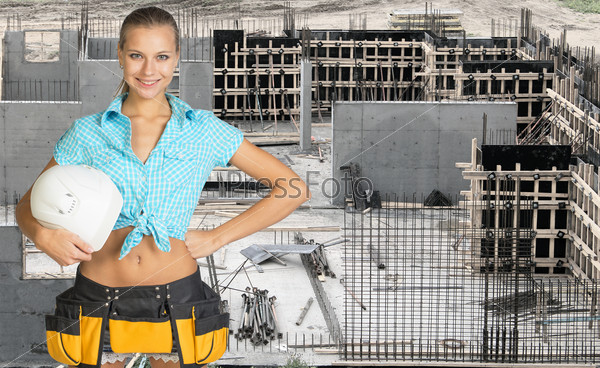 Young woman holding hard hat