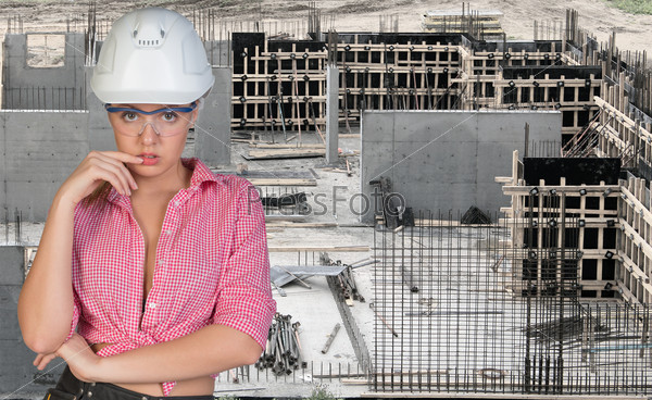 Young woman in hard hat and protective glasses