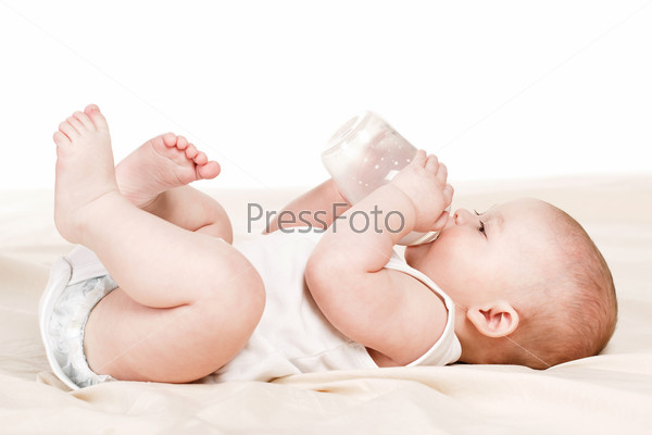 baby drinking milk from bottle. Baby holding bottle himself. sweet funny baby drinking. Pretty baby girl drinking milk from bottle