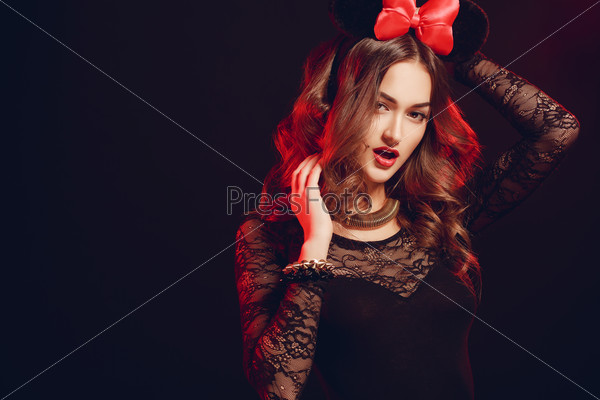 Beautiful brunette model in expensive lace lingerie. A woman dressed as a fashion cartoon mouse with big ears. Fashion art photo