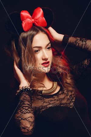 Beautiful brunette model in expensive lace lingerie. A woman dressed as a fashion cartoon mouse with big ears. Fashion art photo