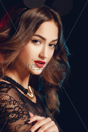 Beautiful brunette model in expensive lace lingerie. A woman dressed as a fashion cartoon mouse with big ears. Fashion art photo. Emotional female portrait.