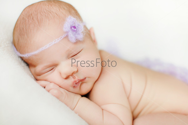 Infant baby boy sleeping peacefully. Little newborn baby boy 14 days, sleeps. infant sleeps in a dream emotions. Carefree sleep little baby with a soft toy on the bed