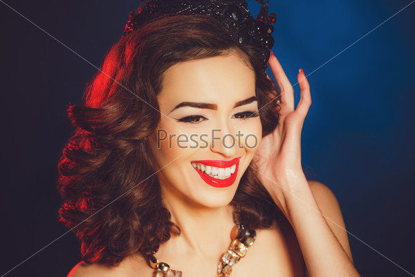 sexy woman in black crown. Beautiful young woman posing with a crown on her head