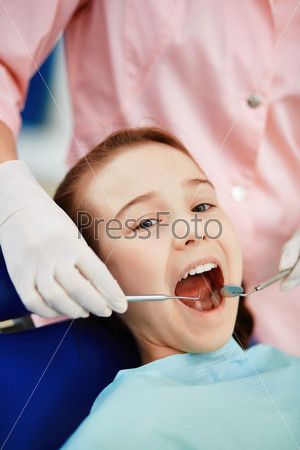 Cute child having mouth checkup
