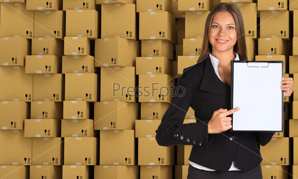 Young businesswoman in black suit with folder and blank paper on cardboard boxes set background