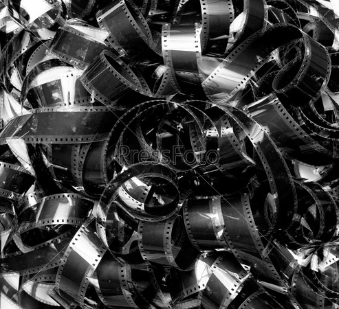 Unrolled heap 35mm movie filmstrip carpet vintage black and white background