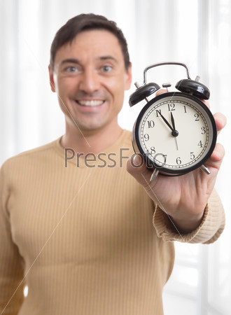 man holding alarm clock