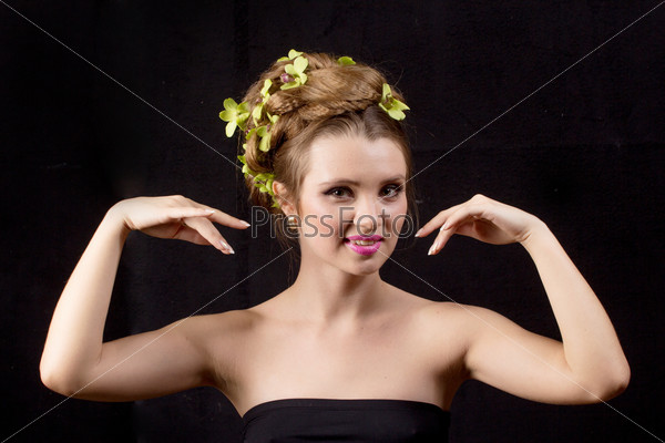 Beautiful woman with orchid flower in hair posing