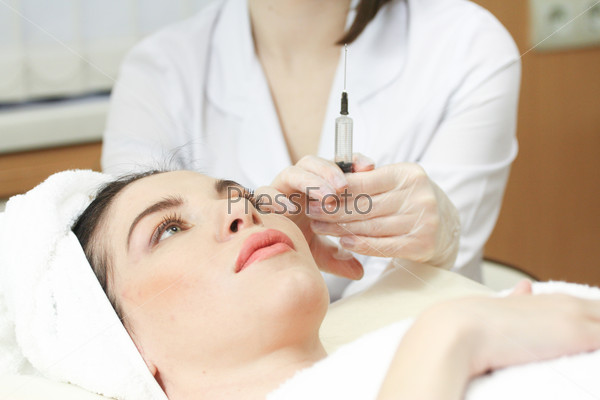 Woman Having Botox Treatment At Beauty Clinic, close up. Focus on syringe