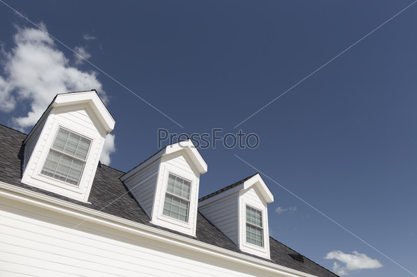 Roof of House and Windows Against Beautiful Deep Blue Sky.