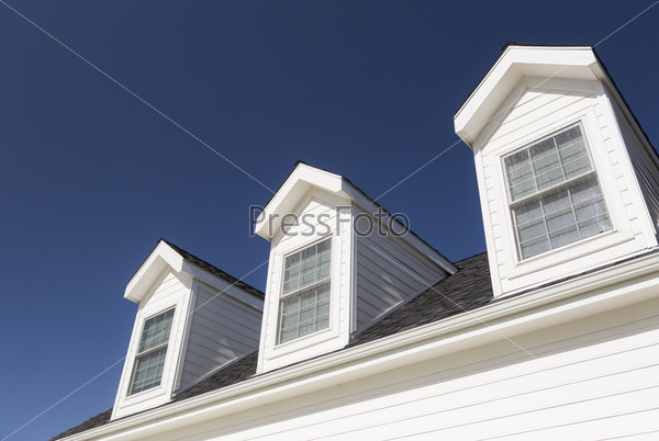 Roof of House and Windows Against Beautiful Deep Blue Sky, stock photo
