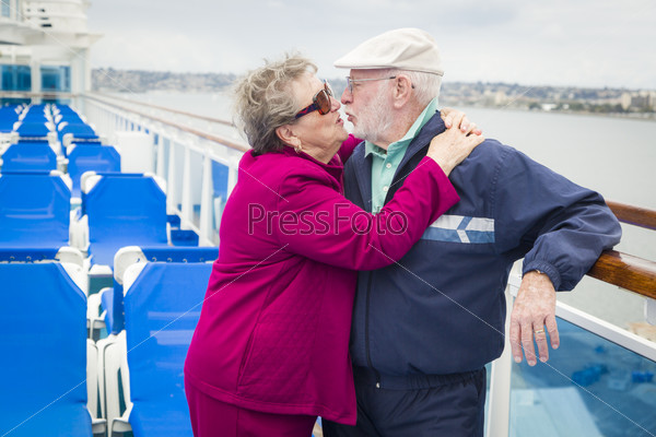 Senior Couple Kissing on Deck of Cruise Ship