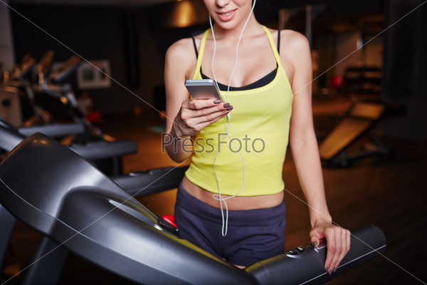 Fit girl with smartphone
