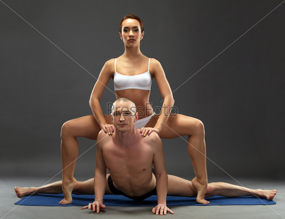 Stock Photo: Yoga. Flexible athletes posing at camera