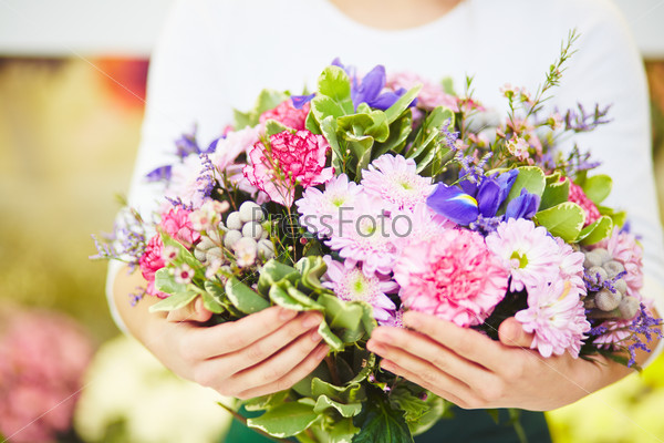 Florist holding big bouquet of fresh flowers