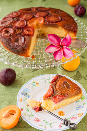Homemade upside-down plum cake, with slice on plate
