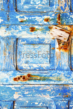 blue stripped paint in the wood door and rusty nail