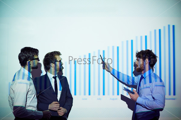 Confident businessman explaining his colleagues chart of financial progress