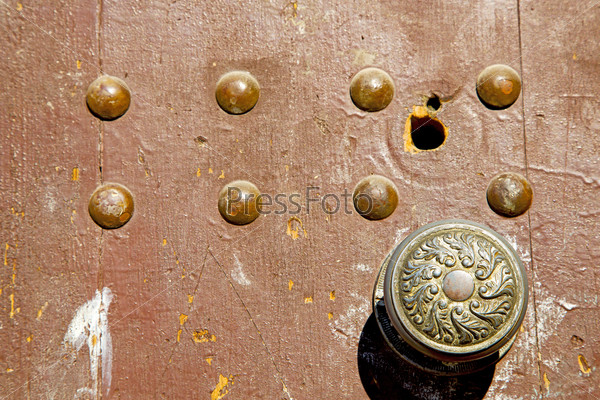 morocco knocker in africa the old wood  facade home and rusty safe padlock