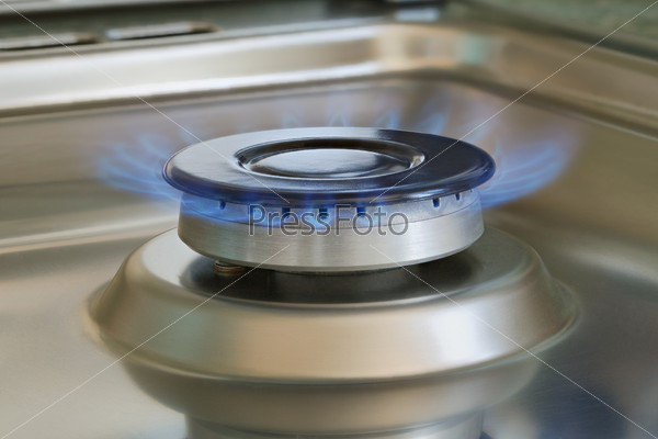 Flames of gas stove, closeup, indoors shot, natural gas